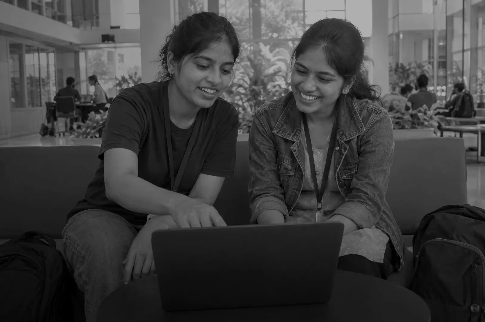 Two university students working through a problem together on a laptop